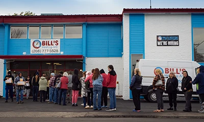 A line of approximately 200 people wait to enter Bill's Heating & AC's Lewiston Location while they give away free space heaters during a natural gas outage.